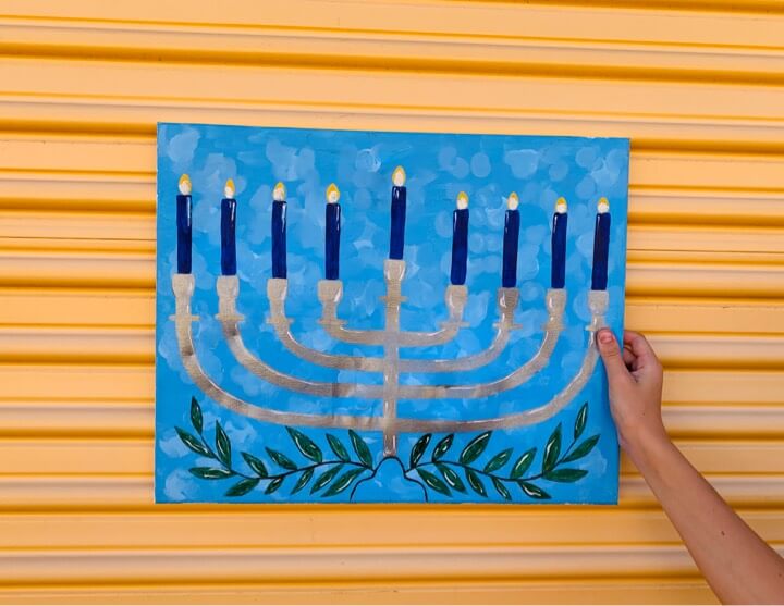 menorah canvas hand holding - Brooke Roe