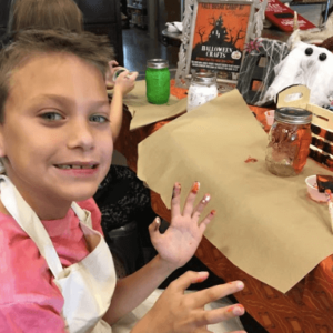 Boy painting at craft camp